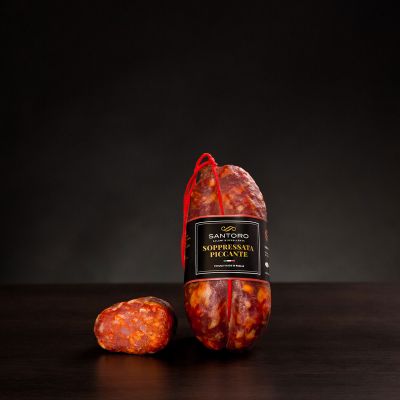 Whole and sliced piece of Santoro spicy Soprressata