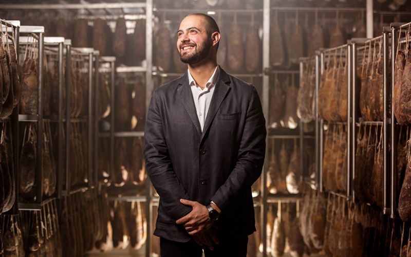 Photo portrait of Nico Caramia in the production center of the salumificio