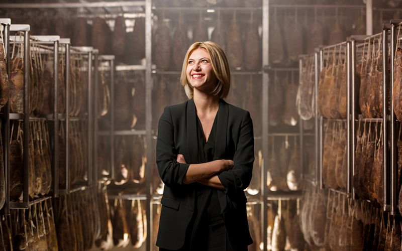 Photo portrait of Micaela Santoro in the production center of the salumificio