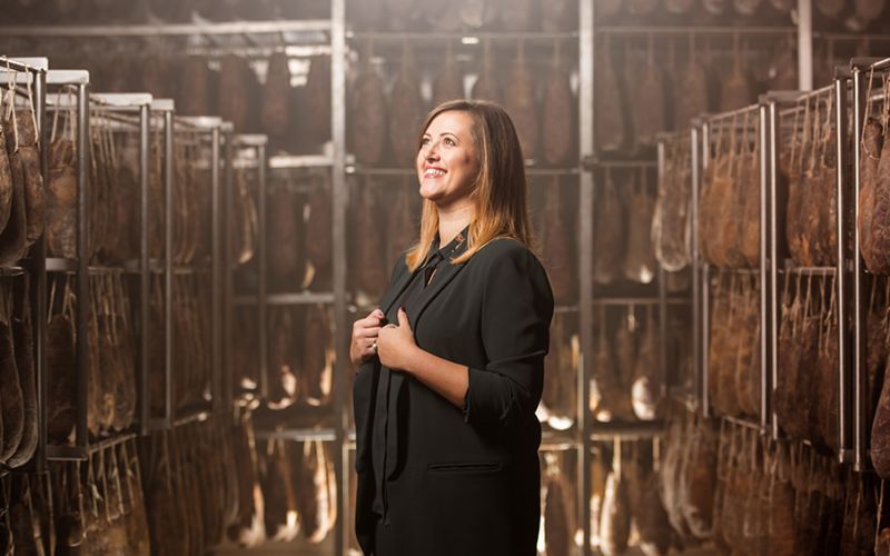 Photo portrait of Angela Santoro in the production center of the salumificio